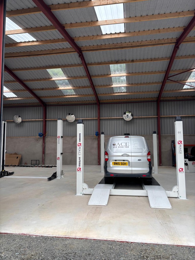 Ace-branded Ford van on a four-post lift inside the Ace Cabs fleet service centre in Antrim