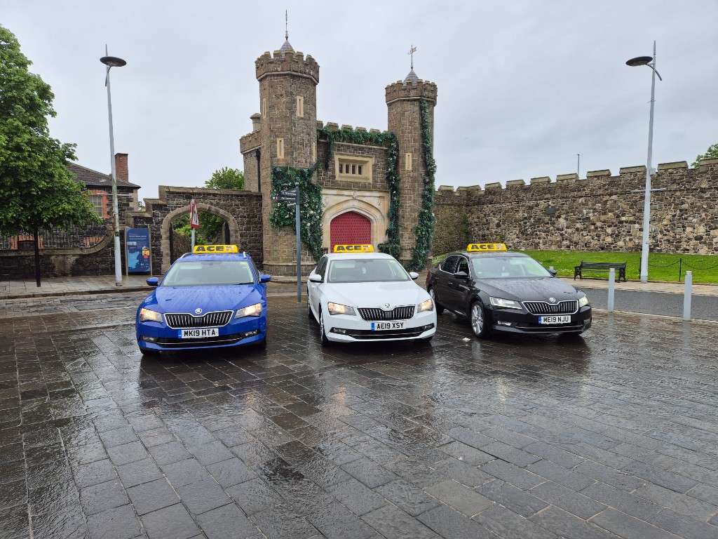Ace Cabs licensed taxi saloons with roof signs at a pickup point in Antrim, Northern Ireland
