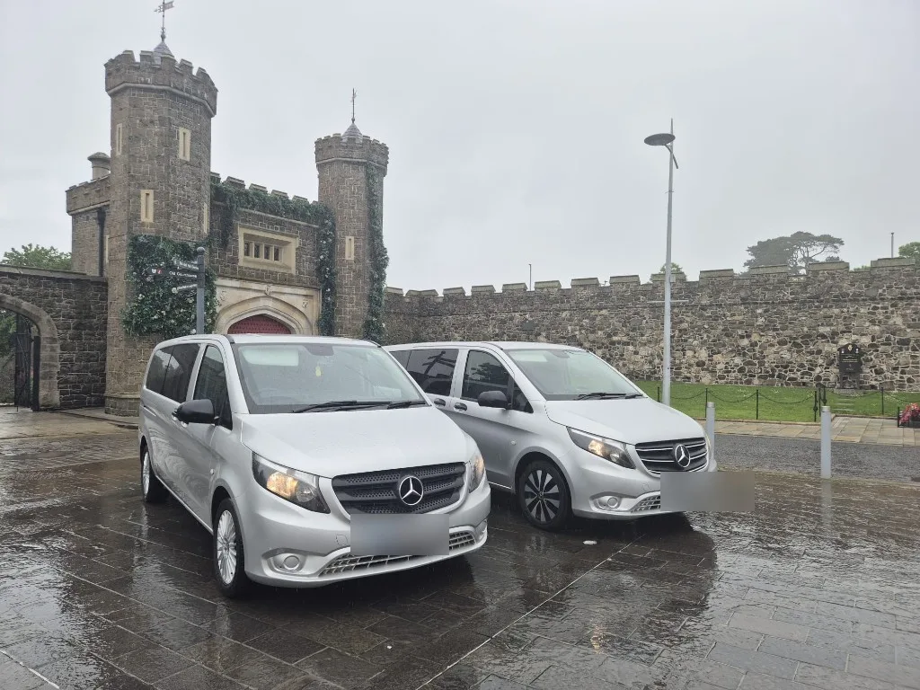 Two silver Mercedes Vito MPVs from Ace Cabs parked at Antrim gatehouse, 8-seater group transport in Northern Ireland