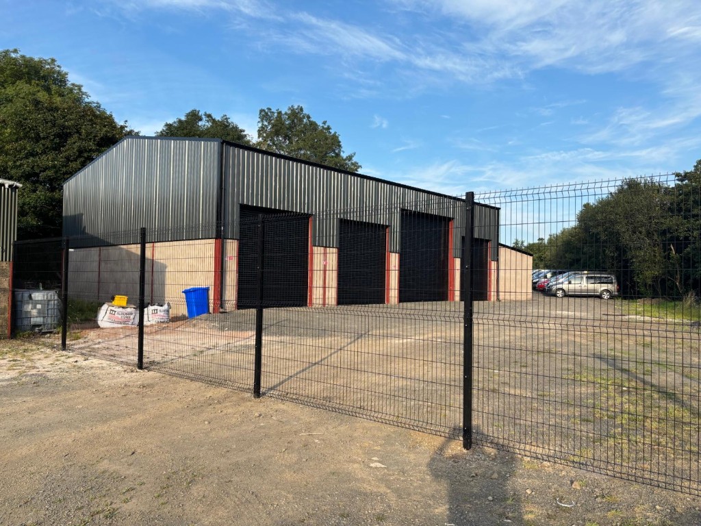 Ace Cabs dedicated garage and service centre exterior in Antrim with multiple roller-shutter fleet bays