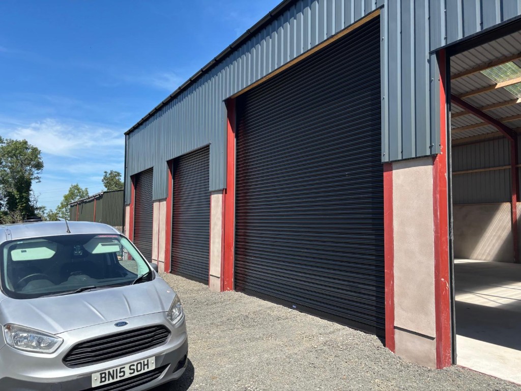 Open service bay at the Ace Cabs fleet garage in Antrim with Ace van ready for maintenance