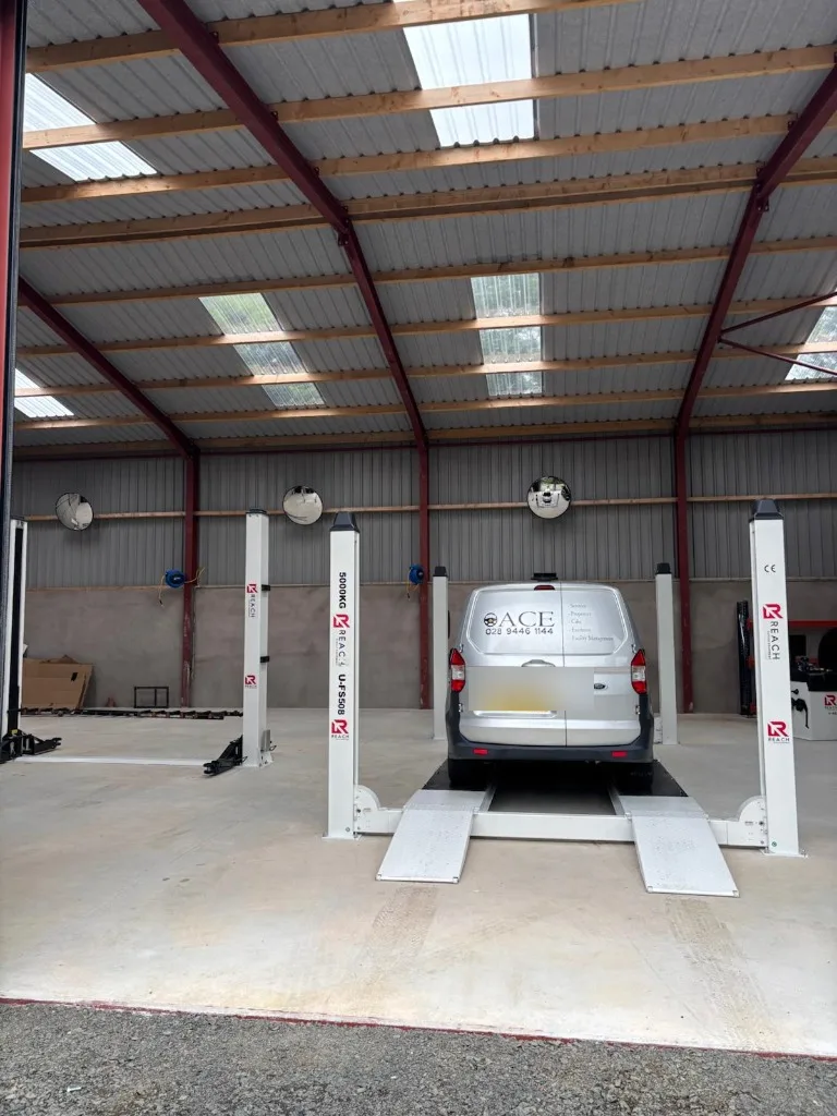 Ace-branded Ford van on a four-post lift inside the Ace Cabs fleet service centre in Antrim